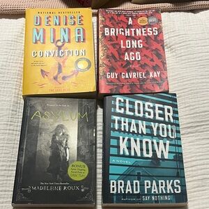 Four Paperback Novels - Yellow, Red, Black & Teal Covers